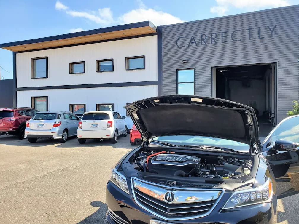 Carrectly's West Town studio with customer vehicles parked out front